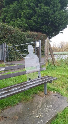 remembrance silhouette on a grey bench